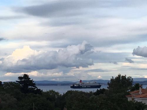 a large boat on the water under a cloudy sky at The Loft in Chios