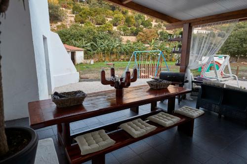 a wooden table with a playground in the background at Quinta da Villa in Cascais