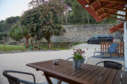 a wooden table and chairs on a patio at Quinta da Villa in Cascais