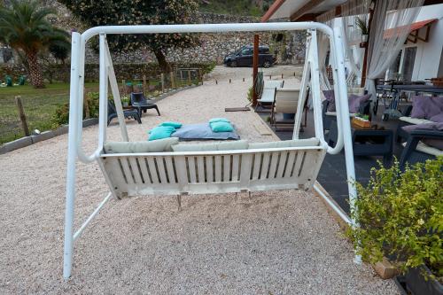 a white swing with two pillows on it at Quinta da Villa in Cascais