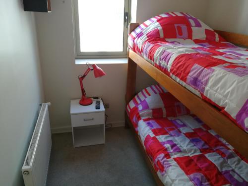 a bedroom with a bed and a lamp on a night stand at Excelente departamento en Las Condes in Santiago