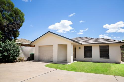 a white house with a garage at Lovely 3 Bed, 2 Bath in the City Centre in Wagga Wagga