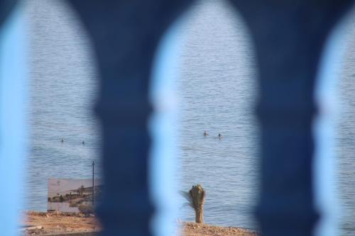 a view of a body of water through a window at GOLVEN Surf in Taghazout