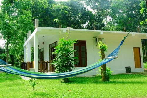 a house with a hammock in front of it at Talalla 170 Villa in Talalla