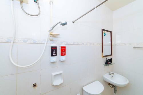 a bathroom with a shower and a toilet and a sink at RedDoorz near Walking Street Angeles City in Angeles