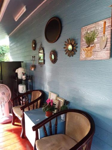 a dining room with a table and chairs and mirrors at Baan JaoKorKluay บ้านเจ้ากอกล้วย in Chiang Rai