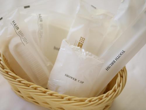 a basket filled with white shopping bags on a table at Asahikan in Shiojiri
