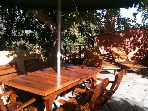 uma mesa de madeira e cadeiras debaixo de um guarda-sol em Rural Las Llanadas em Los Realejos