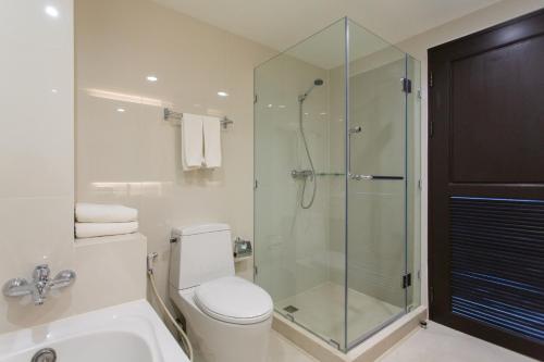 a bathroom with a toilet and a glass shower at Krabi Heritage Hotel - SHA Extra Plus in Ao Nang Beach