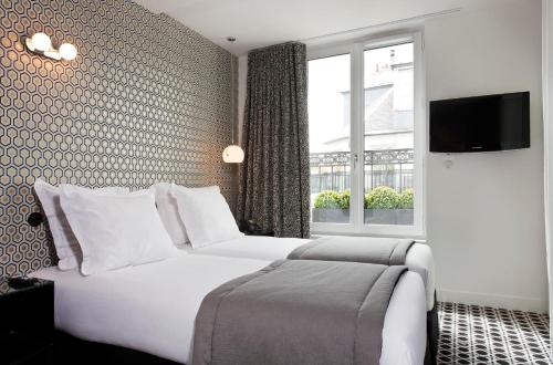 Кровать или кровати в номере Hôtel Emile Le Marais