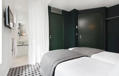 Кровать или кровати в номере Hôtel Emile Le Marais