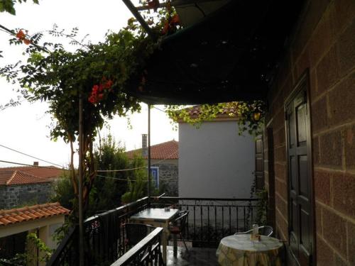 an outdoor patio with a table and a tableablish at ΜΑΧΗ Ενοικιαζόμενα δωμάτια in Mithymna