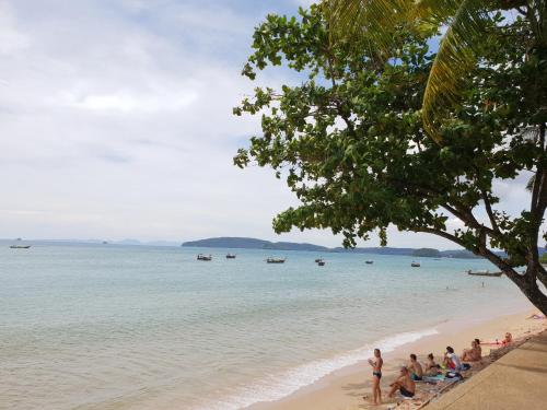 a group of people sitting on the beach at Days Inn by Wyndham Aonang Krabi in Ao Nang Beach