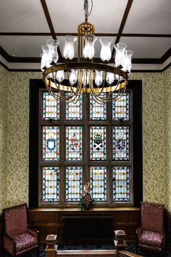 a chandelier in a room with a large window at Woodland Manor Hotel in Bedford