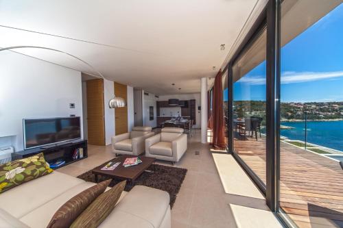 a living room with a view of the ocean at Golden Rays Luxury Villas & Apartments in Primošten