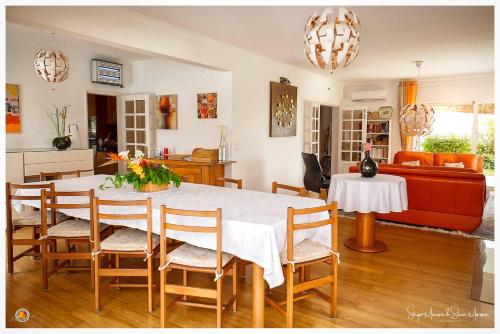 a living room with a table and a couch at B&B Villa Vale Flores in Viana do Castelo