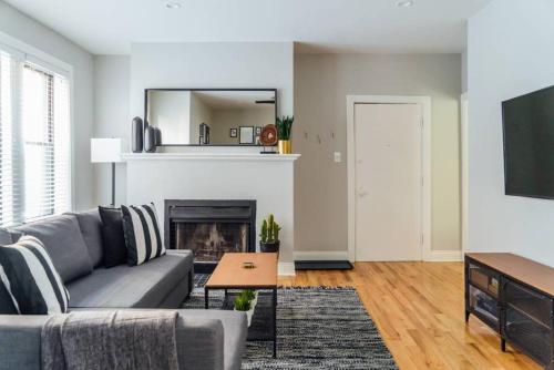 a living room with a couch and a fireplace at Convenient & Newly Decorated 1BR Apartment - Roscoe 1D in Chicago