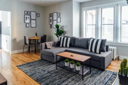 a living room with a couch and a table at Convenient & Newly Decorated 1BR Apartment - Roscoe 1D in Chicago