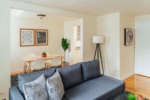 a living room with a blue couch and a table at 1BR Modern Apt in the Heart of the City - Marshfield G in Chicago