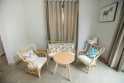 a living room with chairs and a table and a couch at Aonang nine poolvilla in Ao Nang Beach