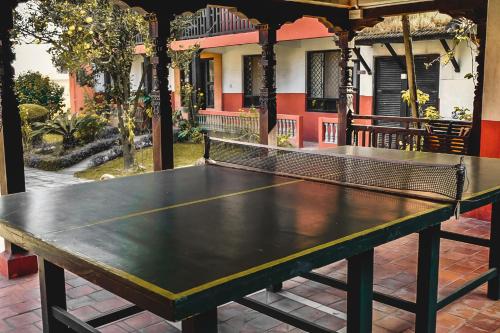 a ping pong table in front of a house at Bhaktapur Guest House in Bhaktapur