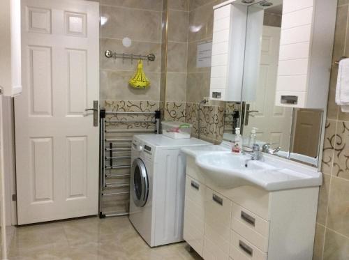 a bathroom with a washing machine and a sink at Sultanahmet Deluxe Yilmaz Apart in Istanbul