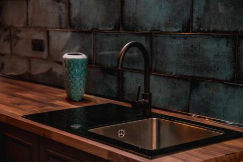 a kitchen counter with a sink and a vase at W1 Katowice in Katowice
