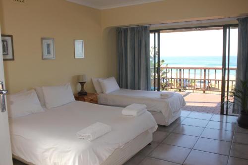 A bed or beds in a room at Glenashley Beach Accommodation - B&B and Backpackers