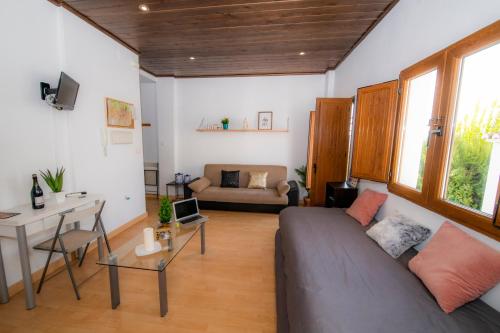a living room with a couch and a table at Carmen Aljibe de la Miel in Granada