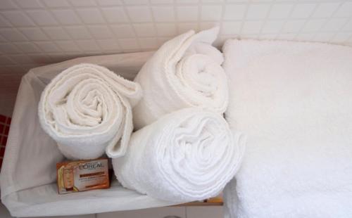 a pile of towels on a shelf next to a bed at Carmen Aljibe de la Miel in Granada