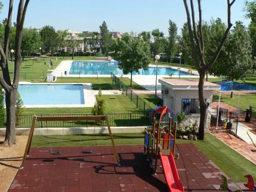 a view of a swimming pool with a playground at APARTAMENTO en MAIRENA DEL ALJARAFE CIUDAD EXPO in Mairena del Aljarafe