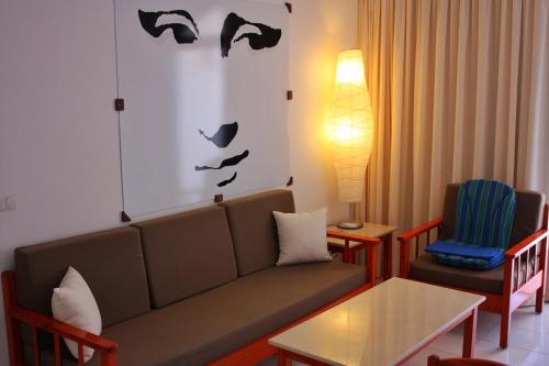 a living room with a couch and a table and chairs at Cura Sol in Playa del Cura