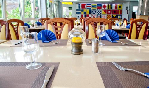 a table with two wine glasses and a bottle on it at Cura Sol in Playa del Cura