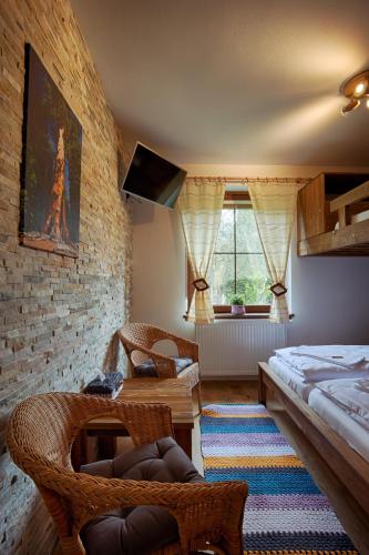 a room with a bed and a table and chairs at Vila Sekvoj in Harrachov
