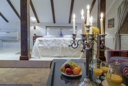 a room with a bed and a table with fruit on it at La Gioconda Boutique Hotel in Odesa