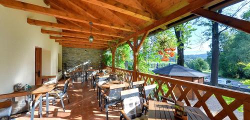 a large room with tables and chairs on a balcony at Pension Restaurant Bobrovník in Lipova Lazne