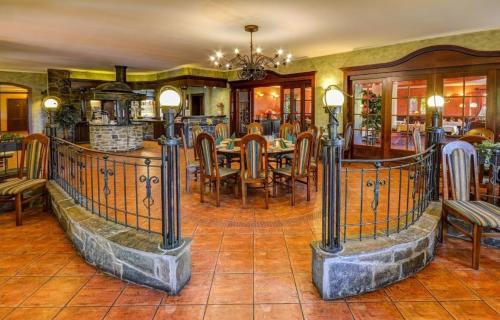 a dining room with a table and chairs at Pension Restaurant Bobrovník in Lipova Lazne