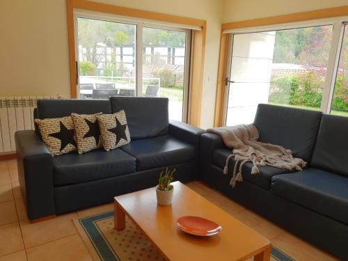 a living room with a couch and a coffee table at Casinhas do Gerês in Geres