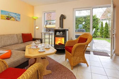 a living room with a couch and a fireplace at Weidenweg 06 in Ostseebad Karlshagen