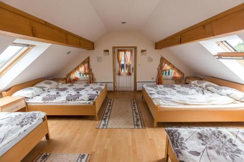 a attic bedroom with two beds and skylights at Apartment Velbana Gorca in Virštanj