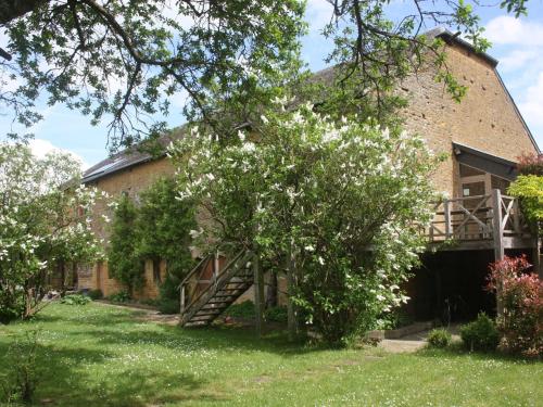 a brick building with a tree with white flowers at Comfortable cottage in Lamorteau with garden in Lamorteau