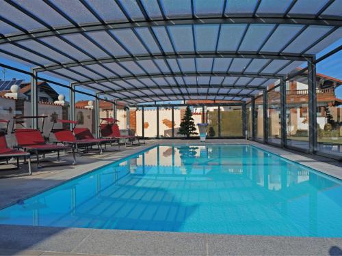 a swimming pool with a pergola over it at Bayerischer Rückzugsort in der Nähe des Chiemsees in Übersee