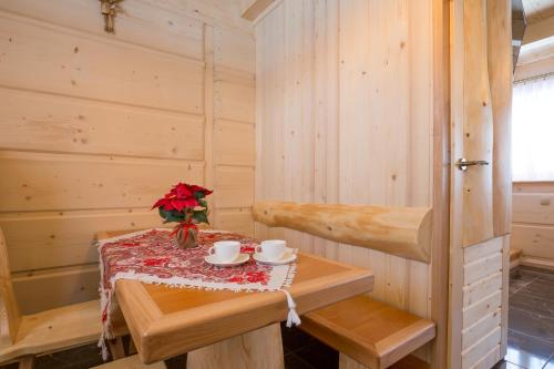 a sauna with a table and flowers on it at Domki u Magdy in Zakopane