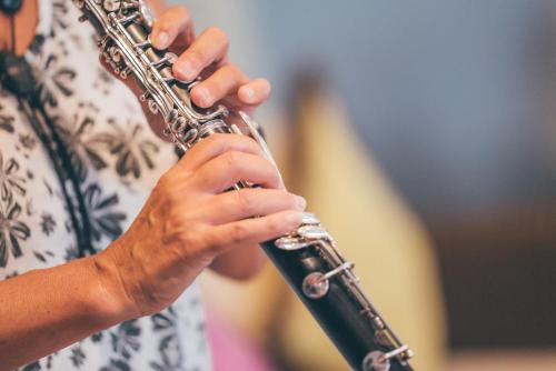 a woman holding a clarinet in her hands at Best Western Plus The Connaught Hotel and Spa in Bournemouth