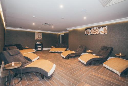 a room with four chairs and a room with at Best Western Plus The Connaught Hotel and Spa in Bournemouth