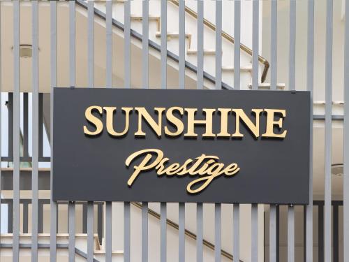 a sign that reads sunshine prestige on a set of stairs at Sunshine Prestige apartments in Ayyorgi