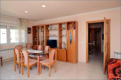 a dining room with a table and chairs at Apartament IMA in Lloret de Mar