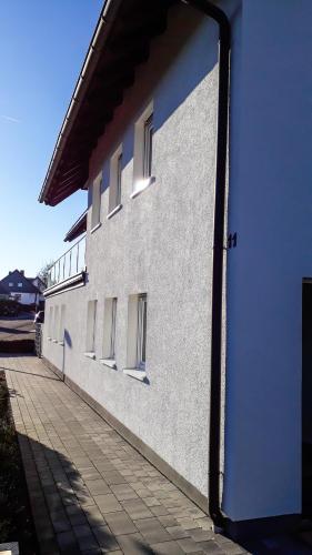 a white building with windows on the side of it at Apartment Schanzenstraße 690 m ü. M in Winterberg