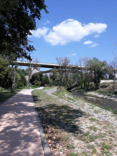 a walking path with a bridge in the background at The Flowers' House in Potenza