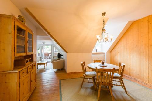 a kitchen and dining room with a table and chairs at Hotel Gut Klostermühle natur resort & medical spa in Alt Madlitz